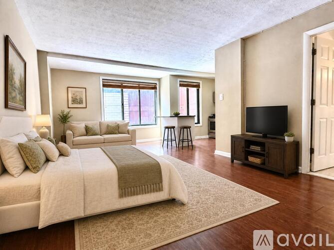 A bedroom with a large bed and a television.