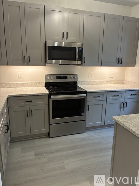 A kitchen with a stove top oven and microwave above it.
