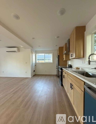 A kitchen with wooden cabinets and a window.