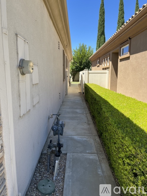 A narrow sidewalk runs between two buildings.
