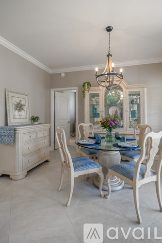 A dining room with a glass table and chairs.