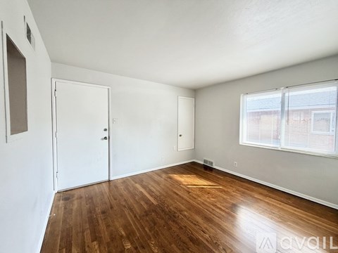 A room with wooden floors and white walls.