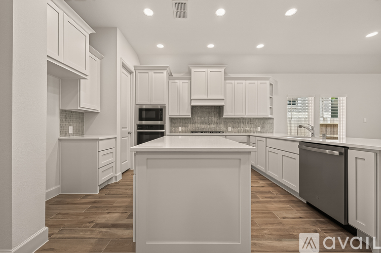 A modern kitchen with white cabinets and a central island.