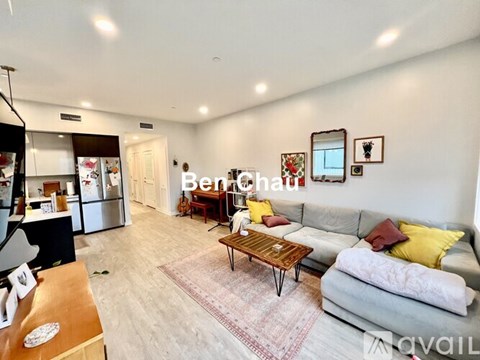 A living room with a grey couch and a wooden coffee table.