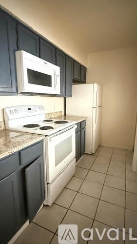 A kitchen with a stove top oven and a microwave above it.