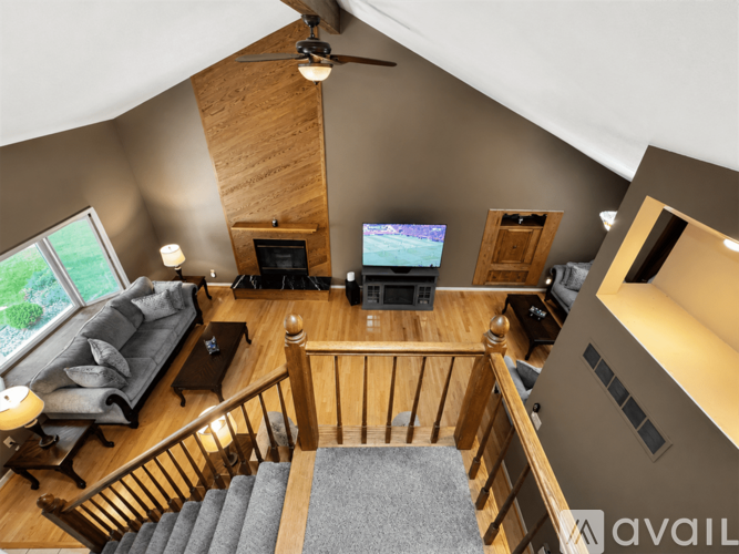 A living room with a grey couch and a television.