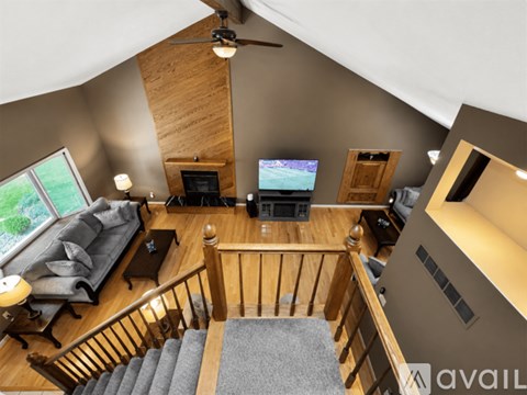 A living room with a grey couch and a television.