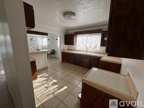 A kitchen with brown cabinets and a white ceiling.