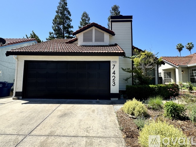 A house with a garage door number 7423.