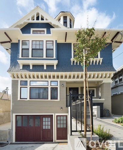 A two-story house with a blue and beige exterior.