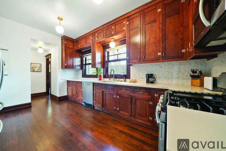 A kitchen with wooden cabinets and a white fridge.