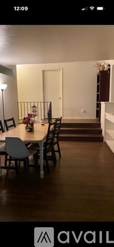 A dining room with a table set for four.