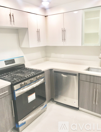A kitchen with a stove, oven, and refrigerator.