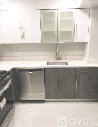 A kitchen with a stainless steel dishwasher and oven.