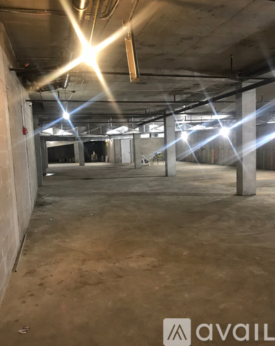 A large, empty industrial space with concrete floors and exposed ceiling beams.