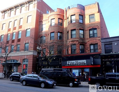 A street view of a building with a sign that says "Pour House".