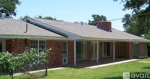 A house with a red brick exterior and a grey roof.