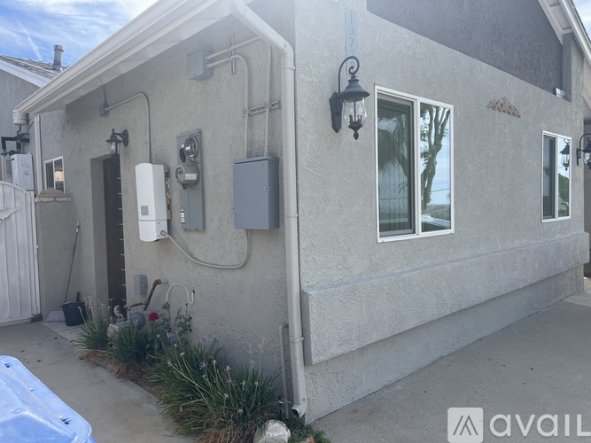 A house with a grey exterior and a white fence.