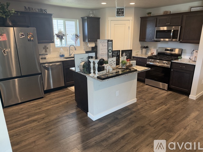A kitchen with a refrigerator, stove, and oven.