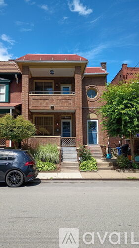 A house with a car parked in front of it.