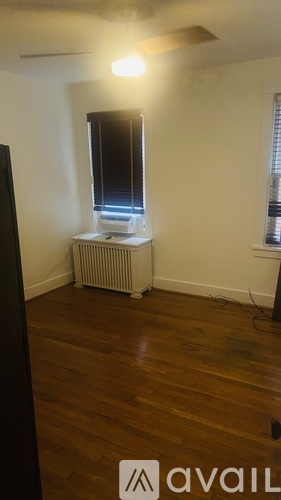 A room with a window and a radiator on the wall.