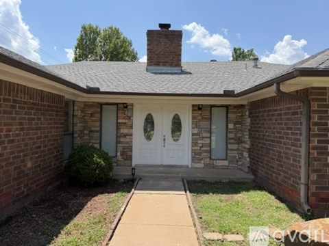 A house with a white door and a brick wall.