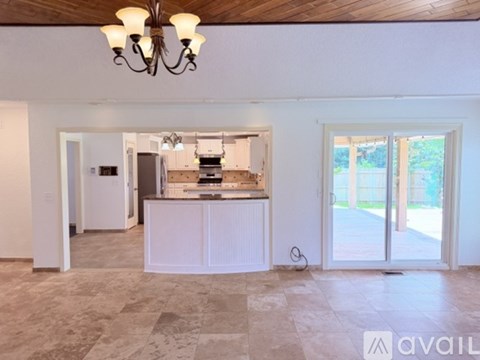 A kitchen with a refrigerator, stove, and oven is available for rent.