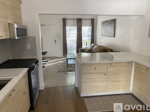 A kitchen with wooden cabinets and a black countertop.