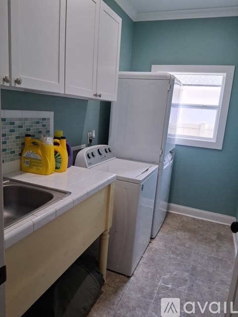 A small kitchen with a white dishwasher and a sink.