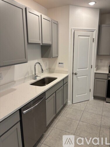 A kitchen with a sink and cabinets.