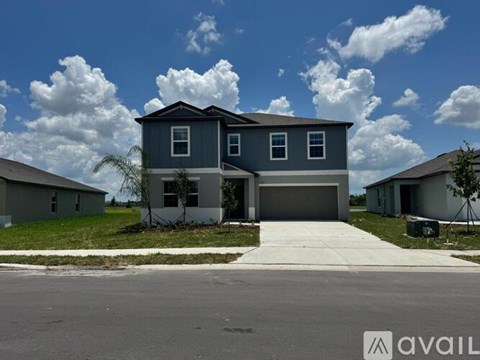 A two-story house with a garage is available for sale.