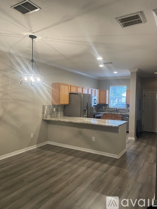 A kitchen with wooden cabinets and a central island.
