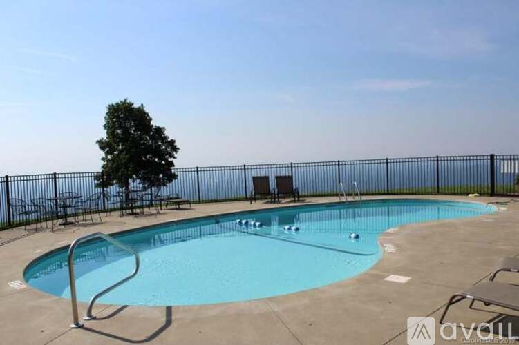 A small pool with a metal fence around it.