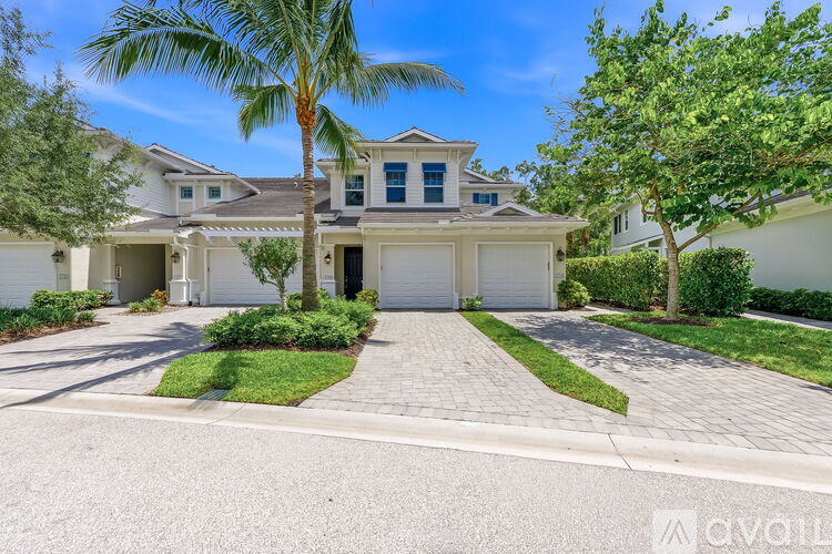 A house with a palm tree in front.