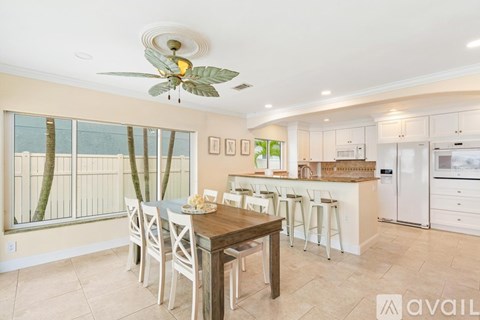 A kitchen with a dining table and chairs is available for rent.