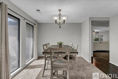A dining room with a table set for four.