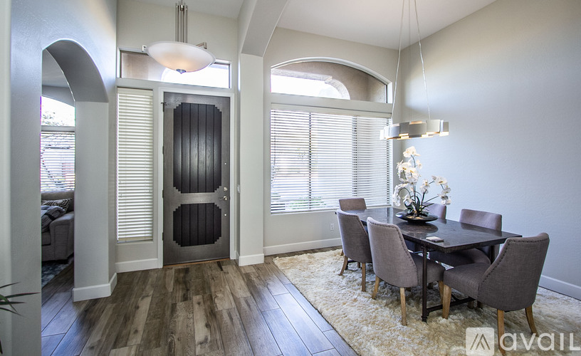 A dining room with a table set for four.