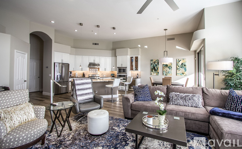 A living room with a grey couch and a coffee table.