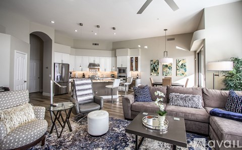 A living room with a grey couch and a coffee table.