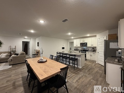 A modern kitchen with a dining table and chairs.