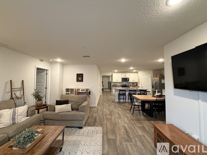 A living room with a grey couch and a wooden coffee table.