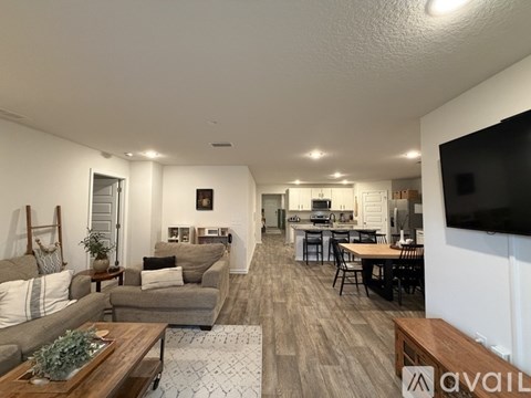 A living room with a grey couch and a wooden coffee table.