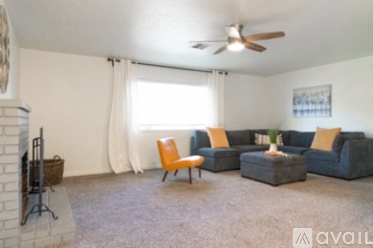 A living room with a grey couch and a yellow chair.