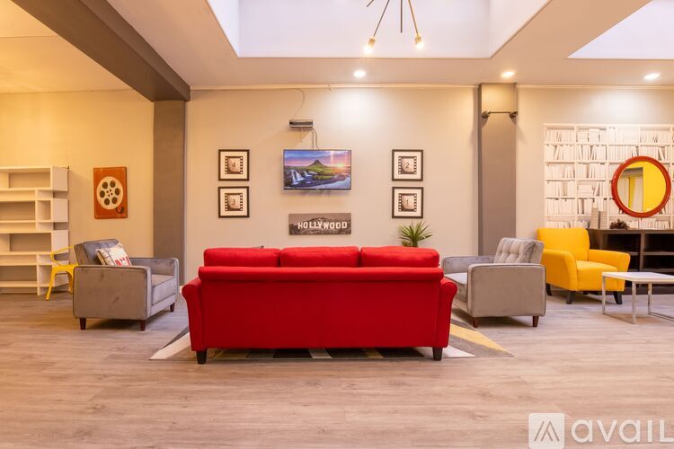 A living room with a red couch and a grey sofa.