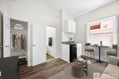 A kitchen with white cabinets and a black dishwasher.