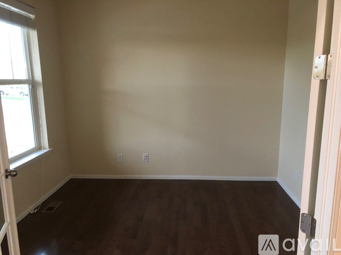 A room with wooden floors and white walls.