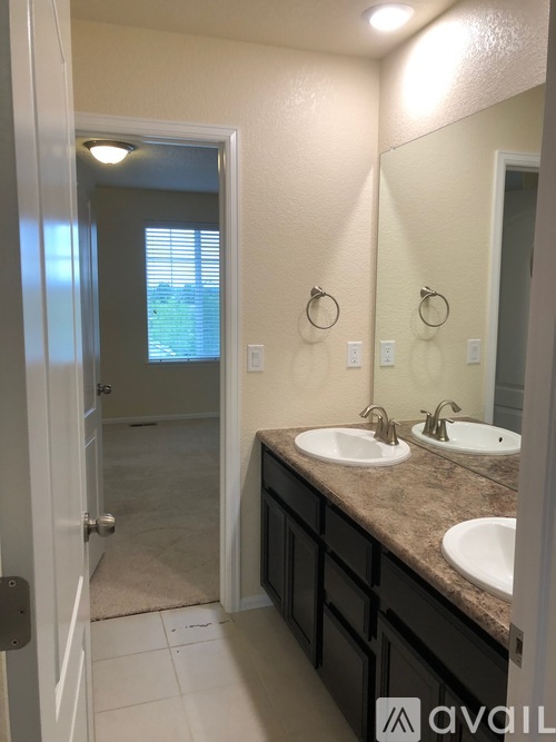A bathroom with two sinks and a mirror.