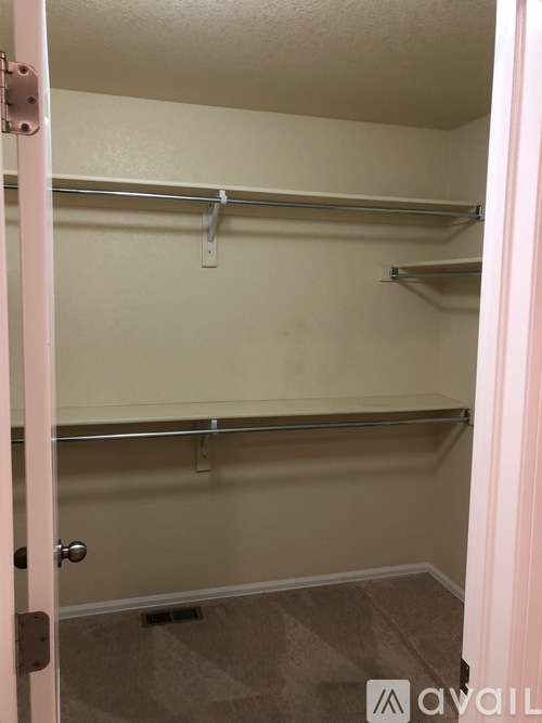 A small walk-in closet with a door open.