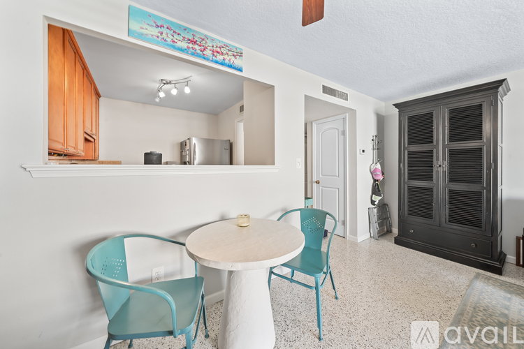 A dining area with a table and two chairs.
