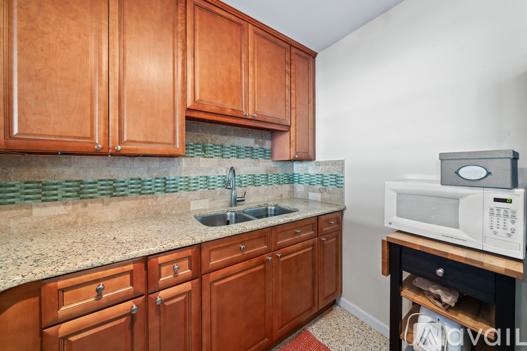 A kitchen with wooden cabinets and a granite countertop.